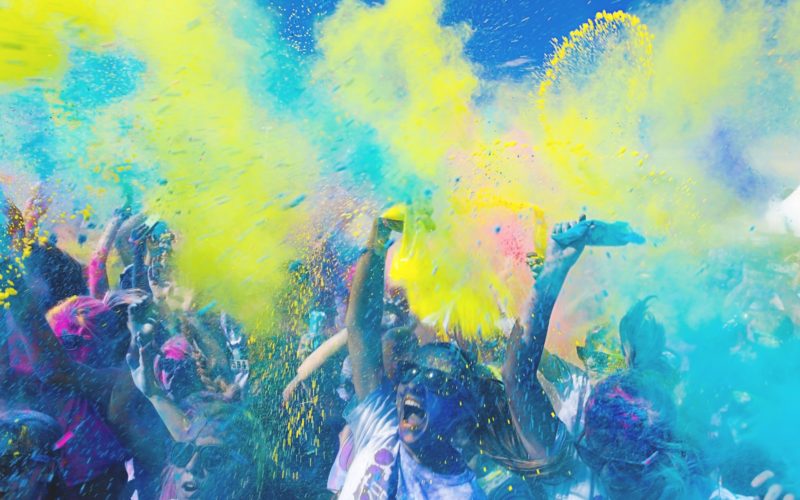 people holding pouches with colored powders